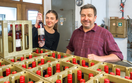 Anna und Rudolf Dentzer vor Kisten mit Weinflaschen